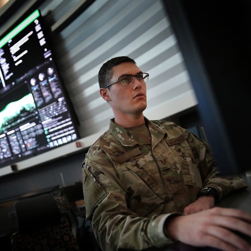 Military member looking at cyber threats on computer