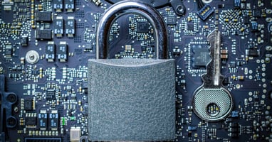 Padlock with key on top of motherboard