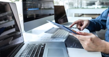 Person reviewing SBOM report at laptop