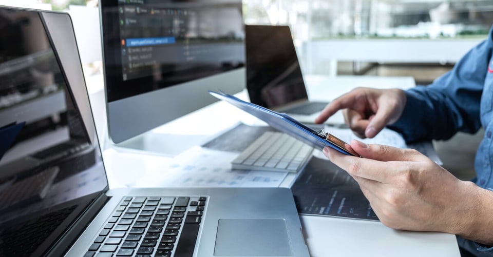 Person reviewing SBOM report on laptop
