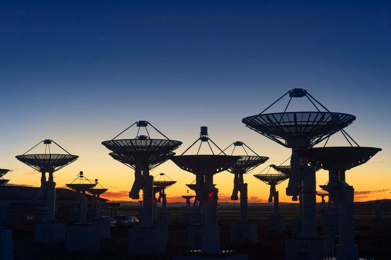 Satellite ground station antenna array at dusk