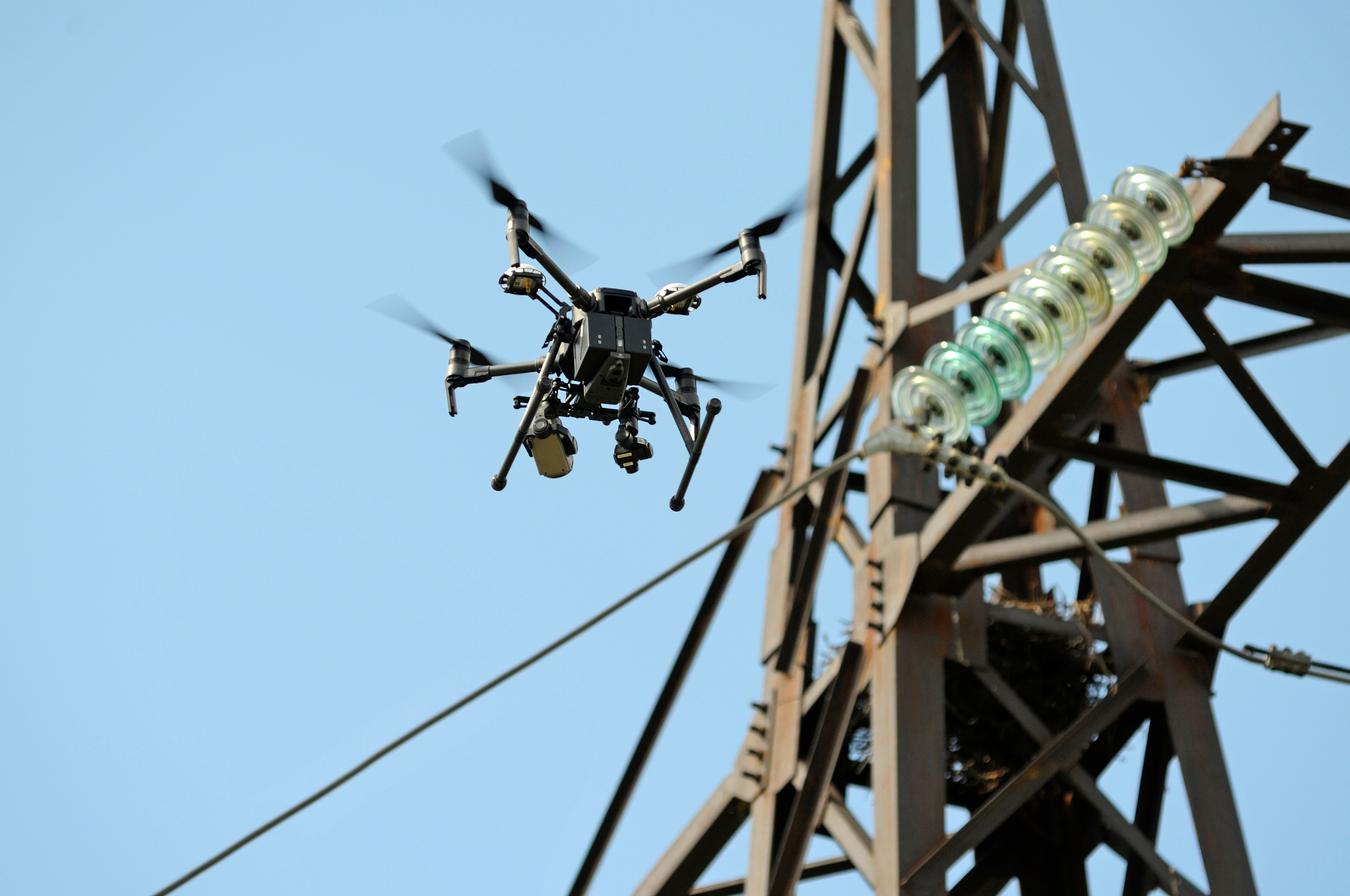 quadcopter drone flying by powerlines