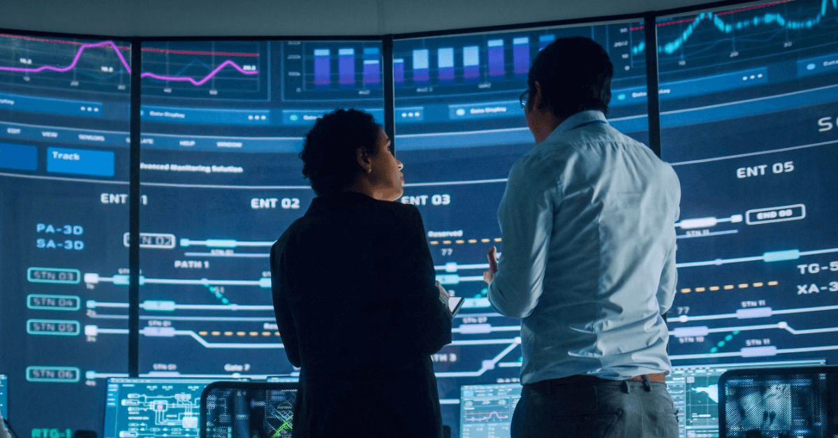 Two colleagues discuss cybersecurity threats