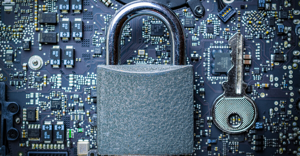Padlock with key on top of motherboard